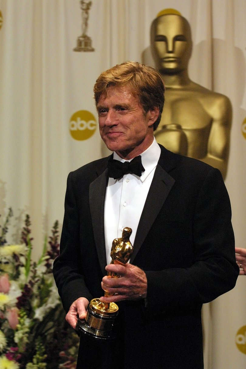 Robert Redford holds an honorary Oscar in recognition of his career, at the 74th Academy Awards in Los Angeles, March 24, 2002.