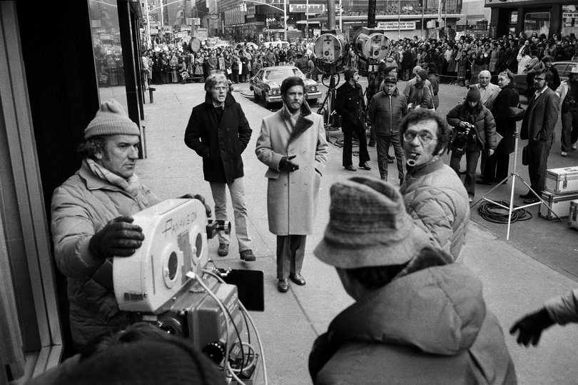 The actors Robert Redford, centre left, and Cliff Robertson with director Sydney Pollack, with pipe, during filming of Three Days of the Condor in Manhattan on February 20, 1975.