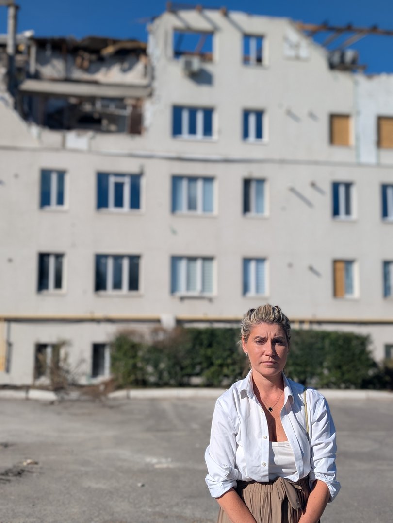 Australian woman, and Founder and Director of UK Friends of Ukraine, Imogen Payter, pictured outside an apartment block in Kharkiv, Ukraine that was attacked with six Shahed drones last month, killing a family of five including a toddler. 