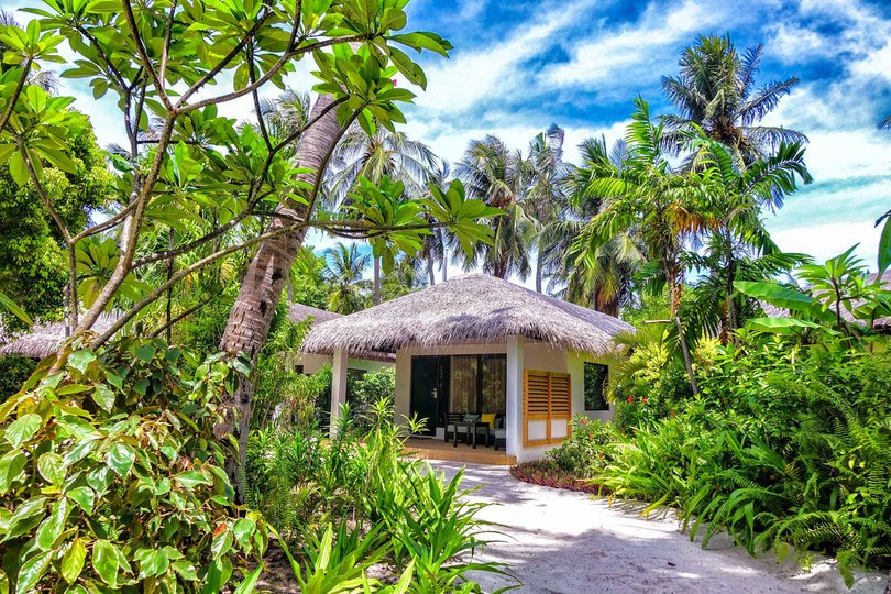 A little island resort in the Maldives with exotic beaches, over water villas, clear and turquoise water.