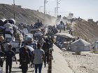 People flee along the coastal Rashid Street from Gaza City, on Tuesday, September 16, 2025.