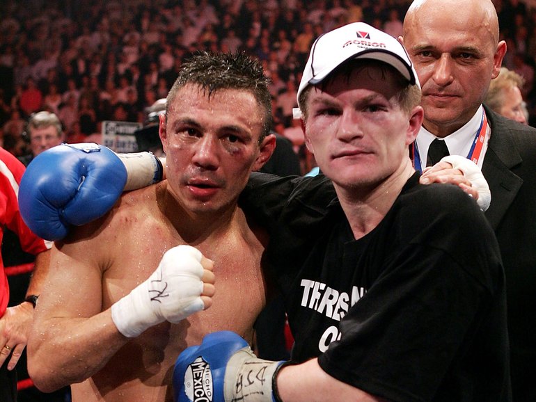 Ricky Hatton (R) celebrates beating Kostya Tszyu (L) during the IBF light welterweight title fight at the MEN Arena on June 4, 2005 in Manchester, England.