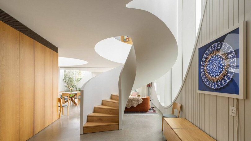 The curved, sculptural staircase.