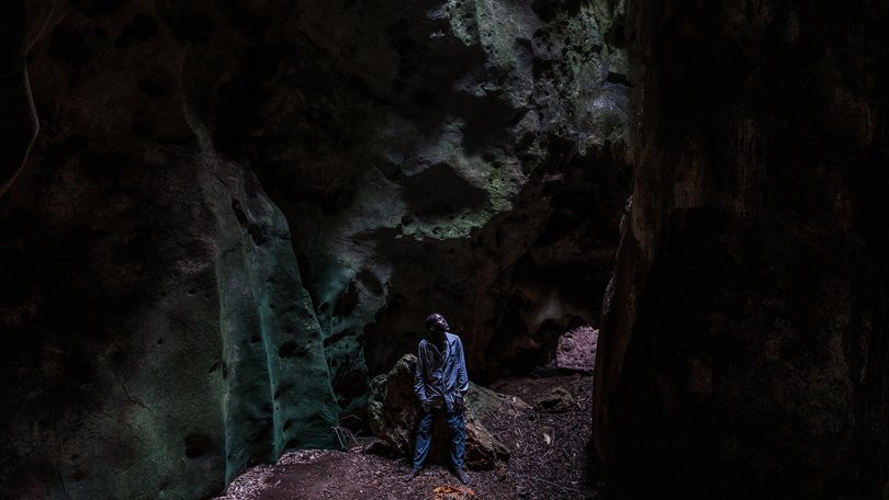 Lugadi Runya Shipa inside one of the caves in the Chasimba area of Kilifi County, Kenya, Oct. 15, 2024. For generations, men like him have guided worshipers through the caverns.