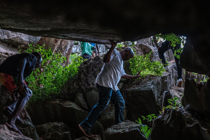Visitors explore the caves in the Chasimba area. The remote area has an extraordinary resource beneath its soil: nearly 100 miles of ancient limestone.