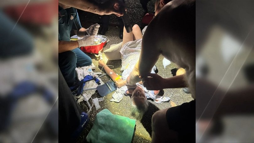 Tammie Rolfe lies injured as paramedics rush to treat her at the scene.