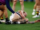 Tom Stewart of the Cats is seen with medical staff.
