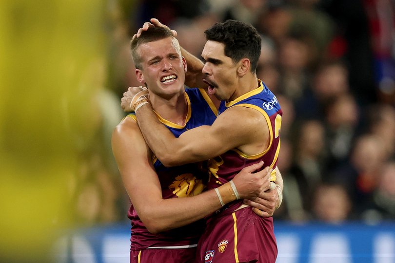 Ty Gallop of the Lions is congratulated by Charlie Cameron after kicking a goal.