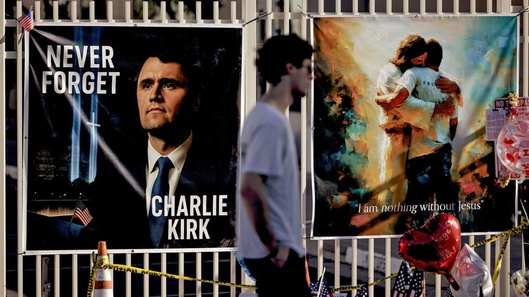 People pay their respects to Charlie Kirk at a makeshift memorial site outside the Turning Point USA headquarters.