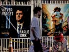 People pay their respects to Charlie Kirk at a makeshift memorial site outside the Turning Point USA headquarters.