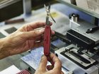 An employee assembles a knife at the Victorinox Swiss Army knife factory in Ibach-Schwyz, Switzerland.