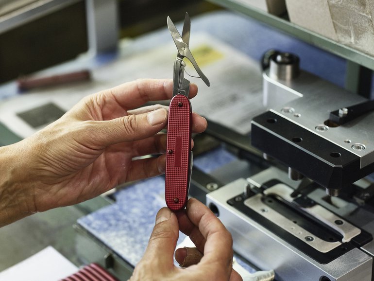 An employee assembles a knife at the Victorinox Swiss Army knife factory in Ibach-Schwyz, Switzerland.