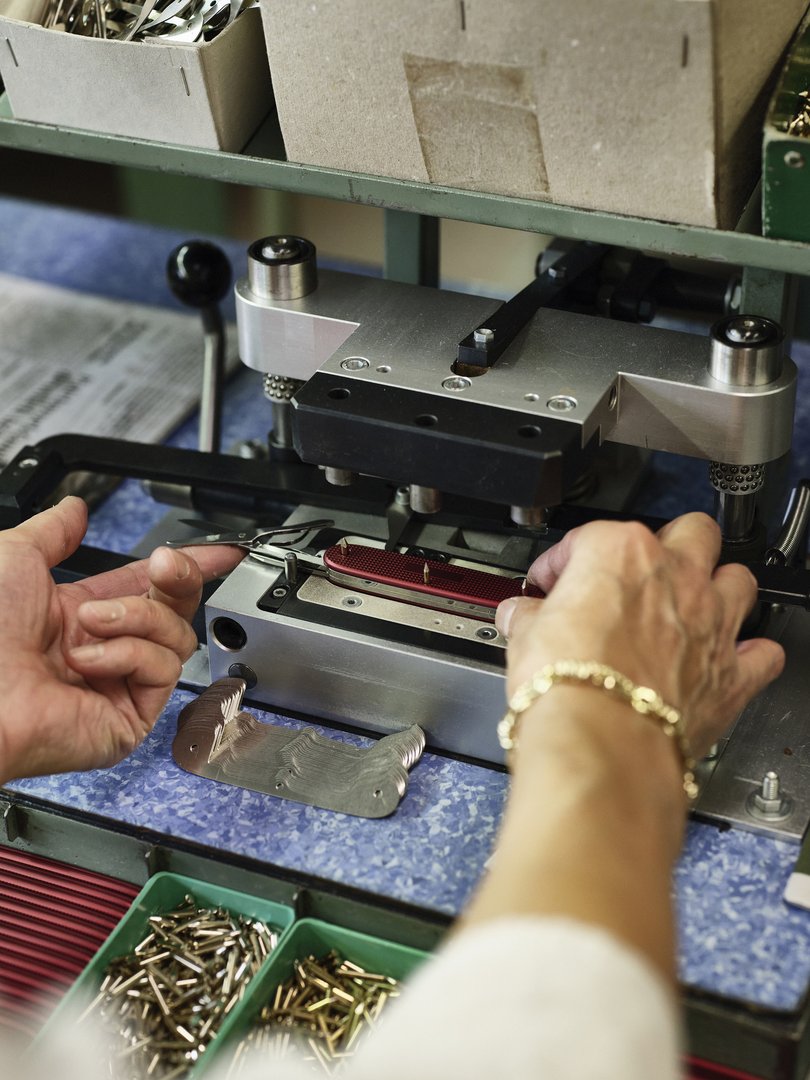 An employee assembles a knife at the Victorinox Swiss Army knife factory.