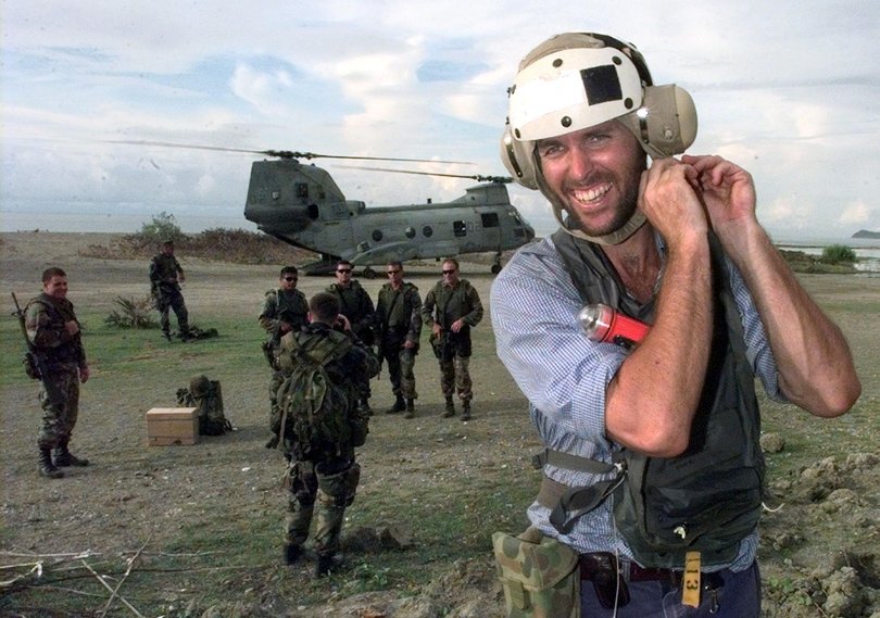 Australian cameraman Harry Burton gets ready to  board a US helicopter in Batugede, East Timor.