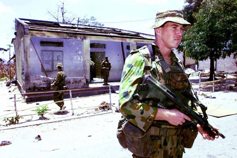 Australian soldiers investigate the house at the centre of the Balibo Five murder allegations in 1999.
