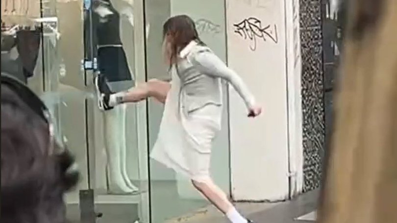 An unidentified woman breaks into a Ji Studio clothing store on Elizabeth St in Melbourne.