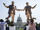 People stop to examine a statue featuring President Donald Trump and deceased financier Jeffrey Epstein outside the U.S. Capitol on Sept. 23. MUST CREDIT: Tom Brenner/For The Washington Post