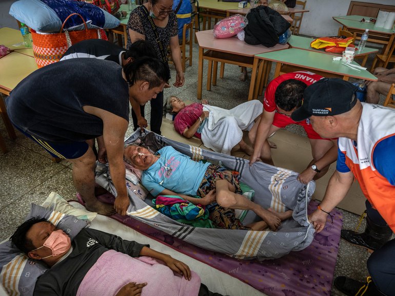 People transport patients to a shelter in a school after Typhoon Ragasa caused a mountain lake to burst its dams in Hualien County, Taiwan, Sept. 24, 2025. Typhoon Ragasa did not make landfall in Taiwan but still wrought havoc on the island. (Lam Yik Fei/The New York Times)