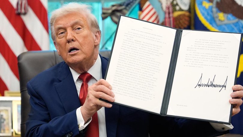 President Donald Trump holds a signed executive order for TikTok's transfer to US owners. (AP PHOTO)
