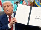 President Donald Trump holds a signed executive order for TikTok's transfer to US owners. (AP PHOTO)
