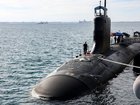 US Navy officers stand guard aboard Virginia-class fast attack submarine USS Minnesota after the vessel docked at HMAS Stirling on February 26, 2025 in Rockingham, Australia. 
