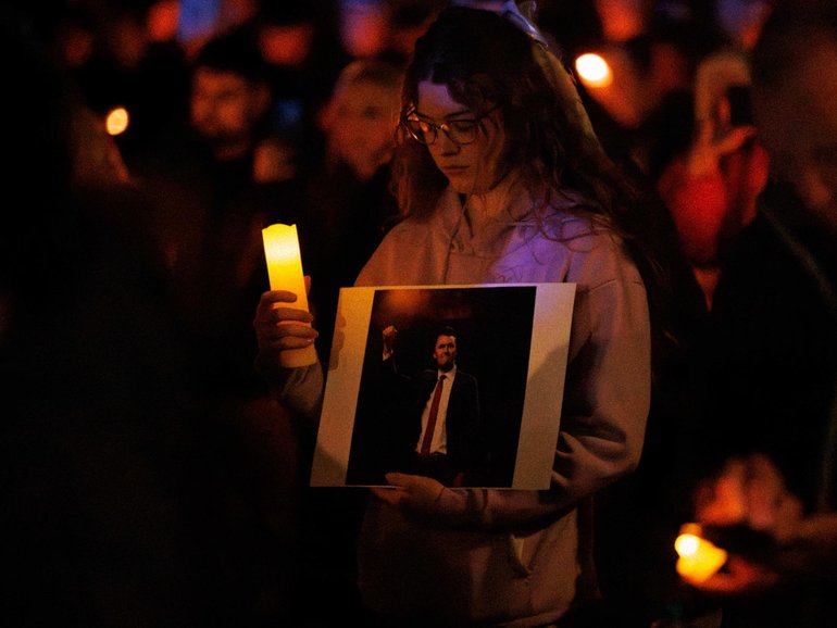 Mourners gathered with candles, some even holding photos of the late right-wing influencer.