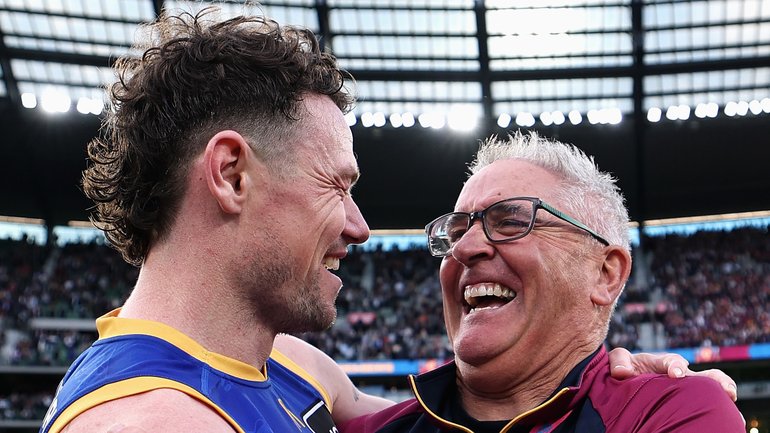 Lachie Neale and Chris Fagan embrace after the win.