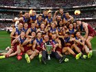 The Lions celebrate winning the premiership cup.