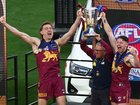 Lachie Neale with Harris Andrews and Chris Fagan on the dais.