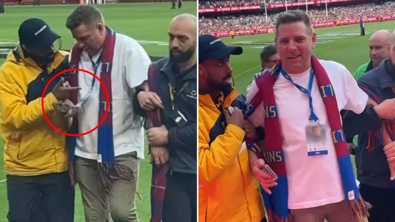 A man believed to be wearing an ex-player’s accreditation is taken away by security.