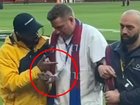 A man believed to be wearing an ex-player’s accreditation is taken away by security.