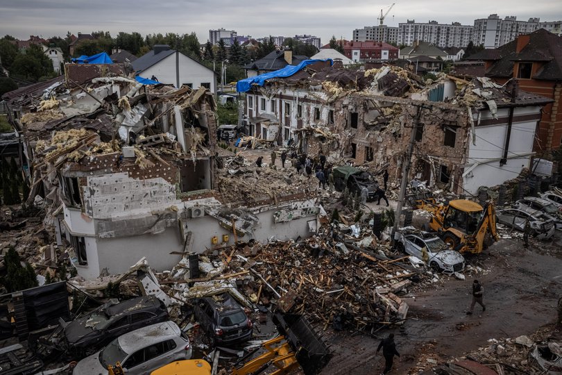 Damage is seen through the window of an apartment block at the scene of a Russian strike on Sunday in Kyiv, Ukraine. 