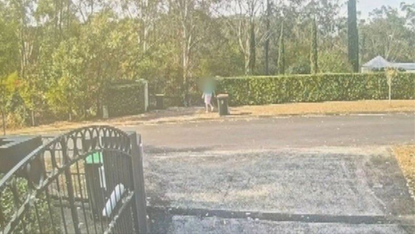 The mother was seen on CCTV calmly walking outside with the bins on Sunday afternoon