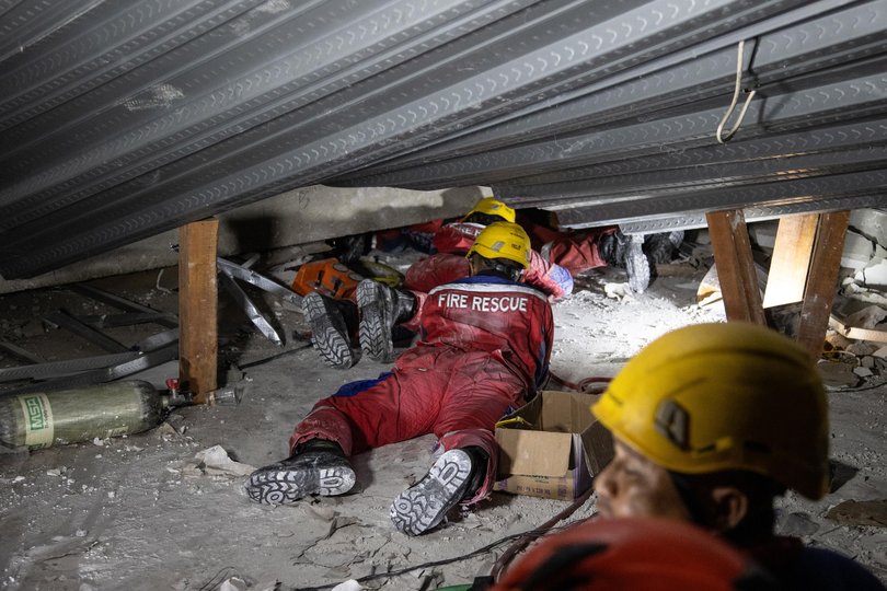 Indonesia National Search and Rescue Agency officers search for survivors.