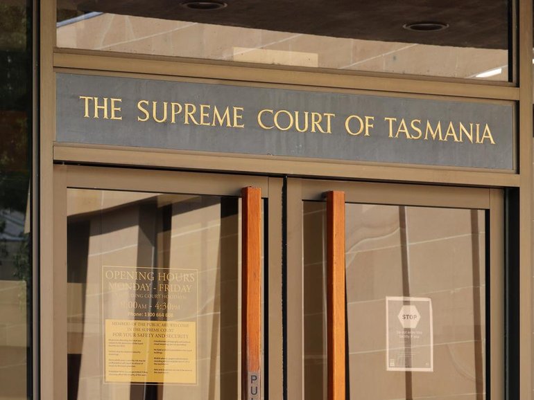 A man jailed for killing six people in a hostel fire is back behind bars for lying in another case.