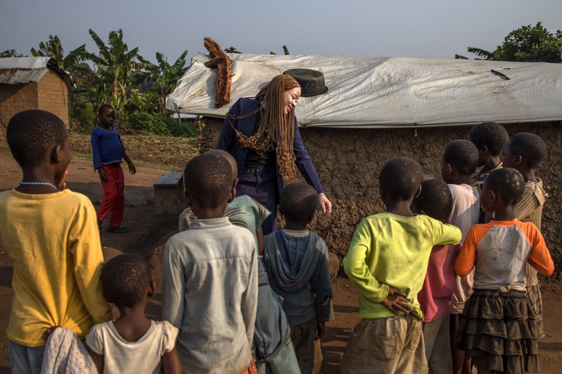 Chantale Zuzi interacts with children in Rwamwanja Refugee Settlement, Kamwenge District, Uganda.