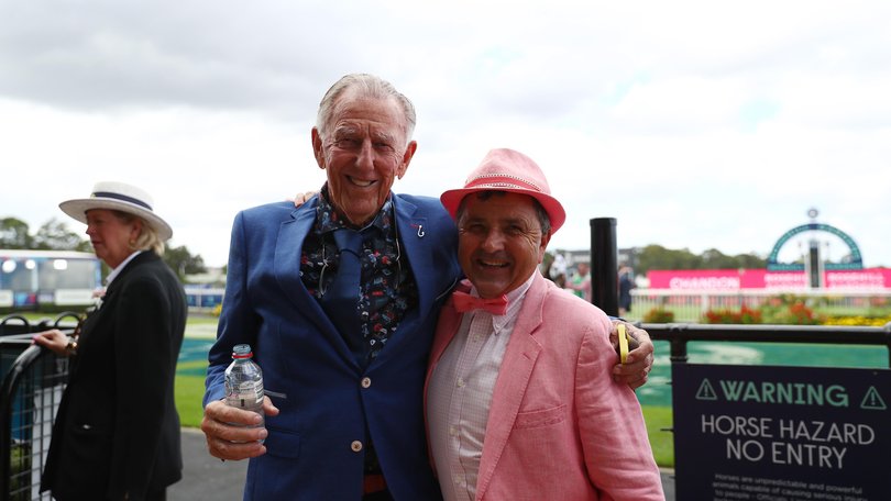 John Singleton poses for a photo at the races with Neil Paine.