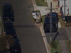 Police have surrounded a house and have called for the people inside to come out.