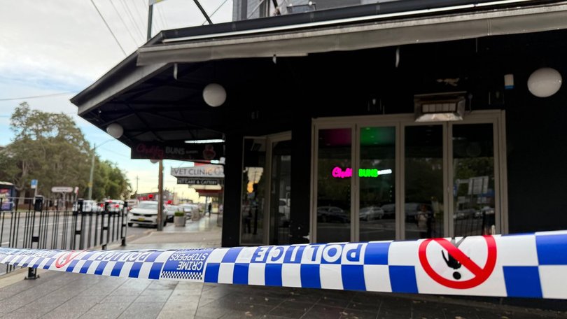 A man is under guard after up to 100 bullets were fired in a street, injuring multiple people. (Rounak Amini/AAP PHOTOS)