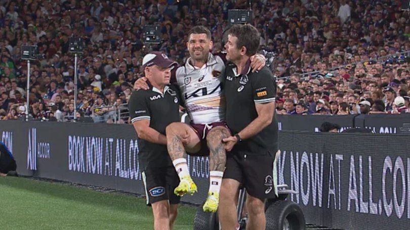 An injured Adam Reynolds is carried from the field during the grand final.