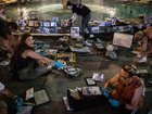 People clean and replace photos and items of victims of the October 7, 2023 Hamas attacks from the Dizengoff Square fountain memorial on October 05, 2025 in Tel Aviv, Israel. 