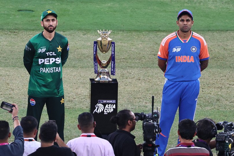 India's captain Suryakumar Yadav (R) and his Pakistani counterpart Salman Agha stand on the field for the toss before the start of the Asia Cup 2025.