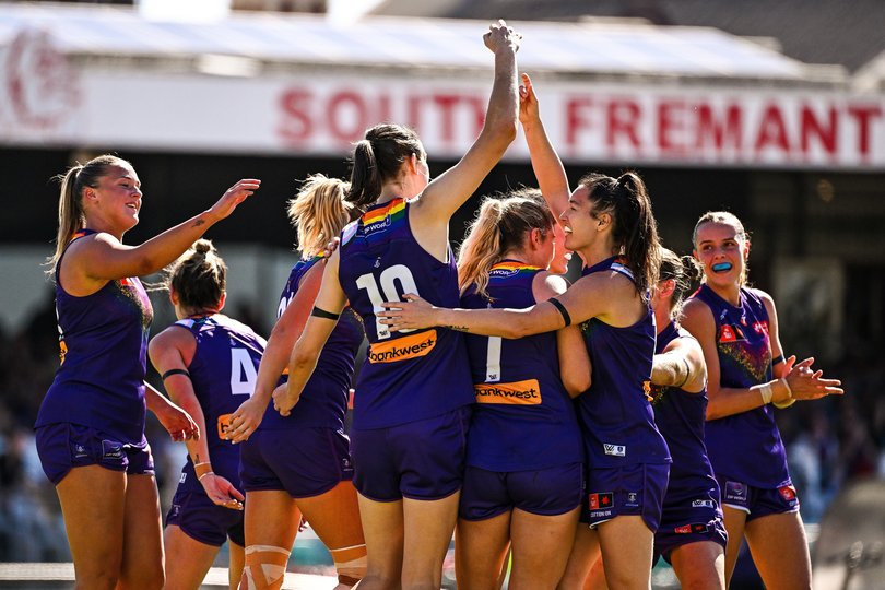 Freo players rally around Aine Tighe.