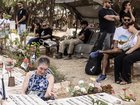 Relatives visit the graves of family members at Kibbutz Nir Oz on Monday. MUST CREDIT: Heidi Levine/For The Washington Post