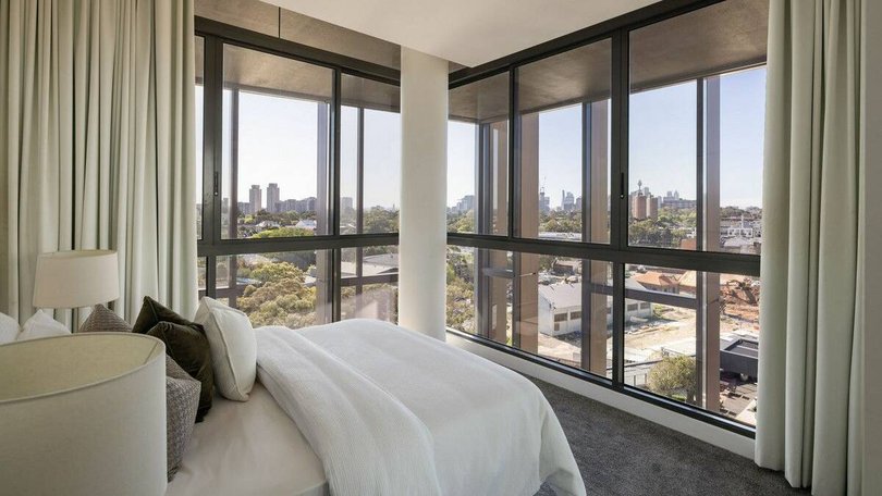 Floor-to-ceiling windows capture panoramic views.