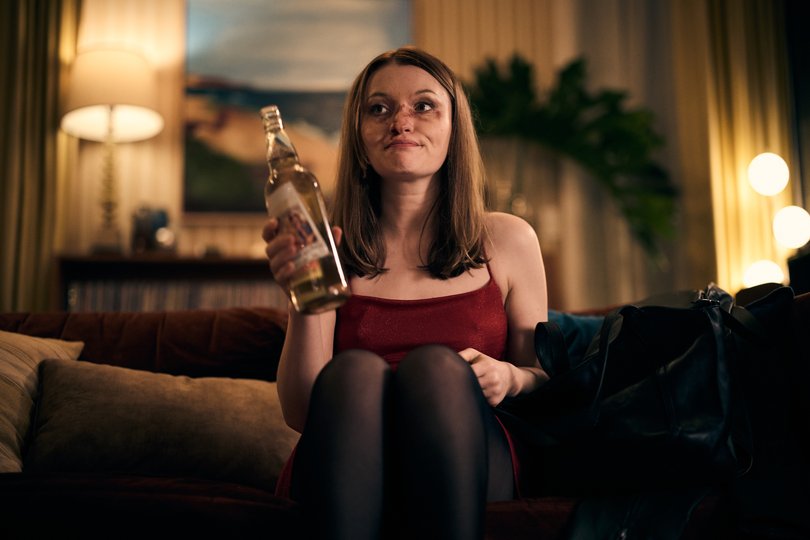 Emily Browning with the bottle of time-travelling tequila.