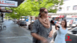 A mother has sprayed water on a 7NEWS reporter’s face outside court.