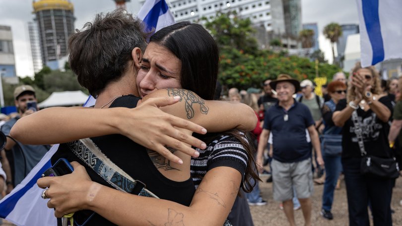 Israelis embrace and celebrate at Hostages Square in Tel Aviv, Israel.