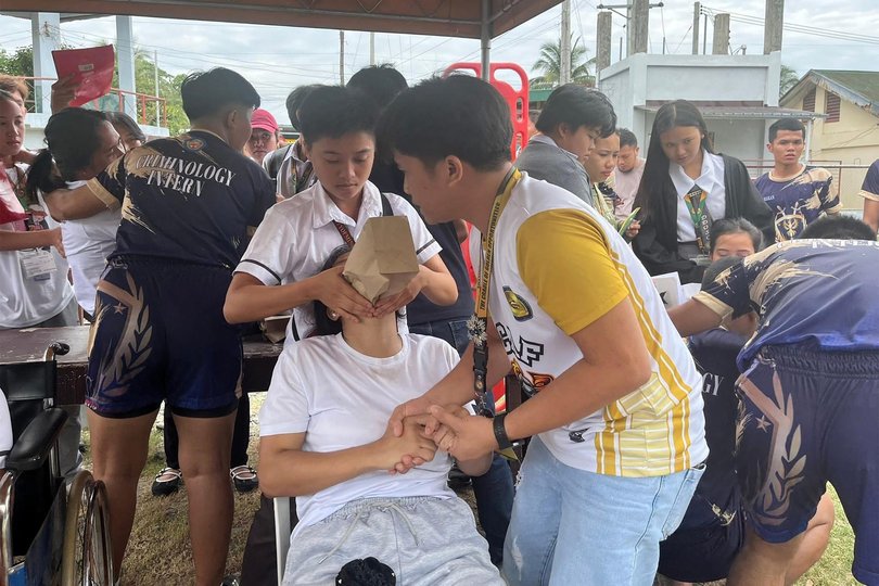 Students at Davao de Oro State College gather outside the school buildings after the earthquake.