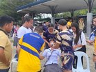 Students helping a fellow pupil as they gather outside the school buildings after an earthquake in Davao de Oro. 